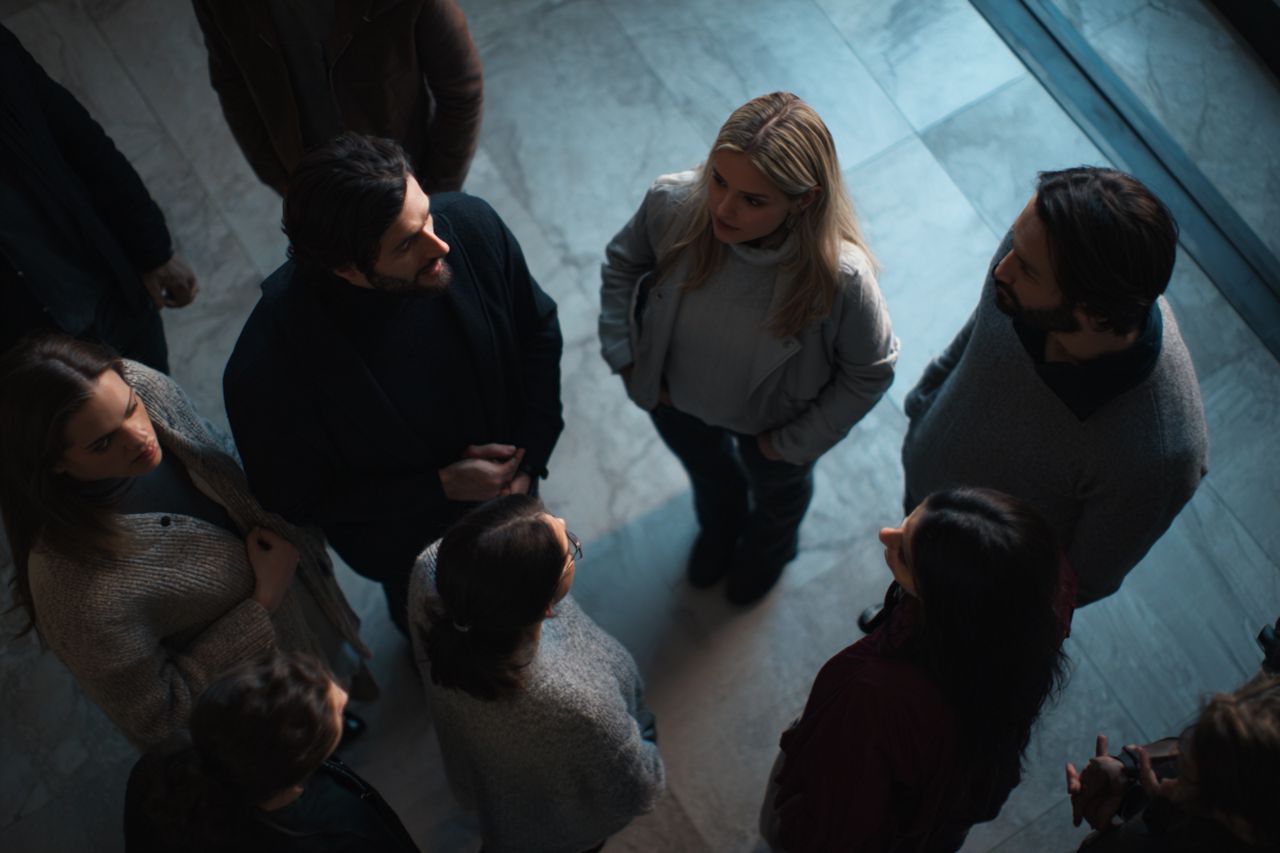 Digital illustration of people observing and judging a stranger during a first impression moment